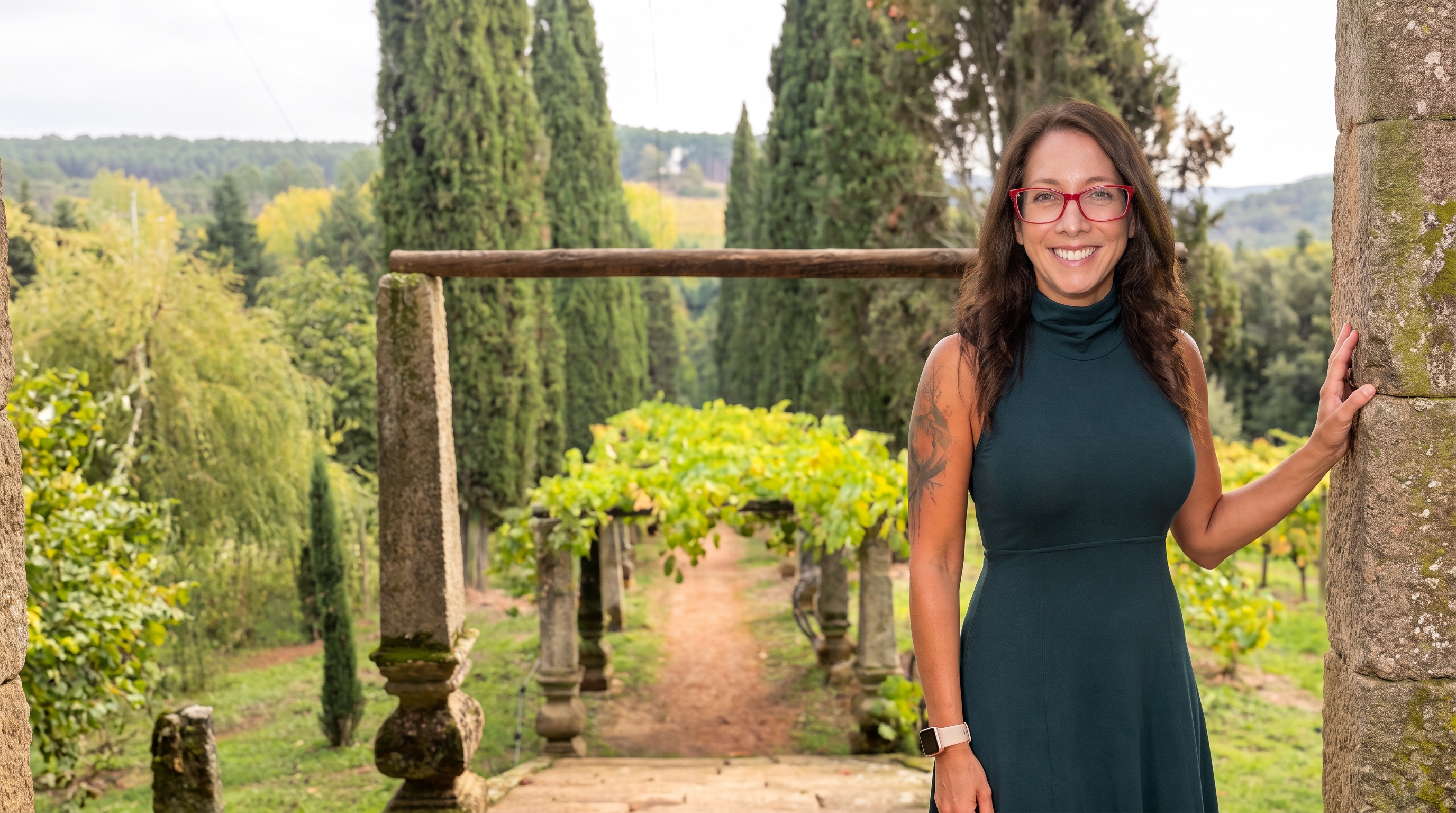 Tara Glover standing in front of a sculptured garden and winery in Porto Portugal